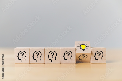 Concept creative idea and innovation. Wooden cube block with head human symbol and light bulb icon photo