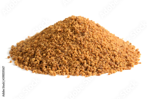 Closeup on a heap of Coconut Sugar. Isolated on White. Dehydrated Sap of the Coconut Palm Tree.
