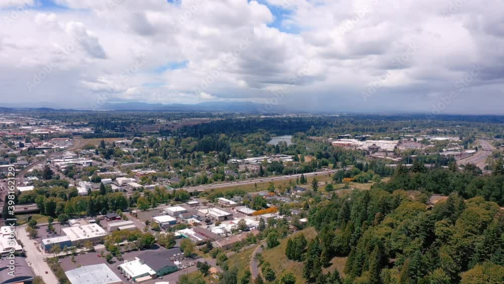Cloudy Summer Sky Over City Skyline With Lush Trees In Eugene, Oregon - aerial Cloudy Summer Sky Over City Skyline With Lush Trees In Eugene, Oregon - aerial