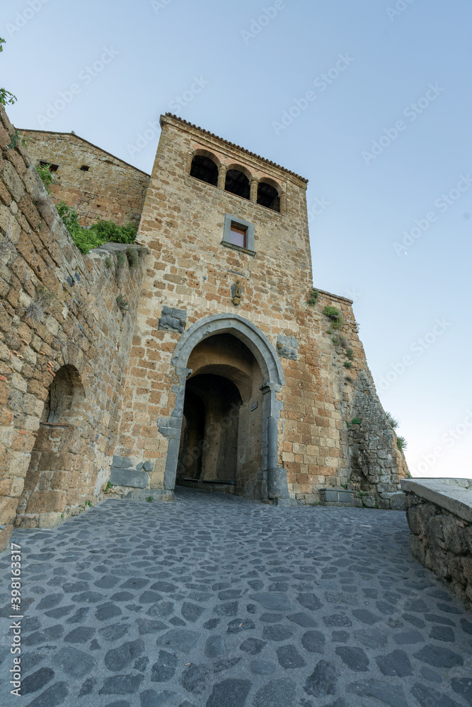 Ancient European castle wall with arch gate in Civita di Bagnoregio, Viterbo, Italy