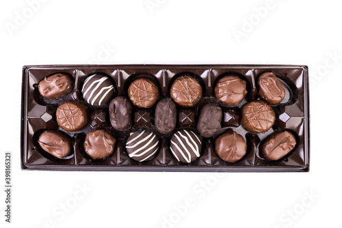 Top down view of square box of milk and dark striped chocolates in a shiny brown display