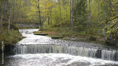 Landscape view of the rushing river in Nommeveski with the trees on the side in Lahemaa National Park in Estonia photo