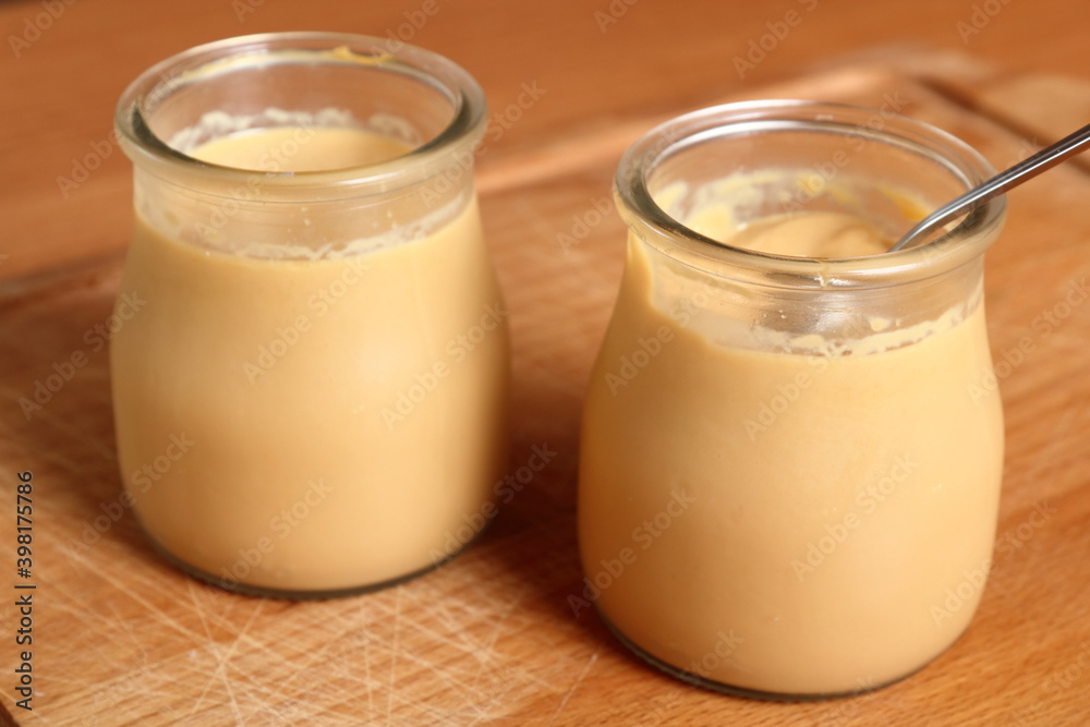 Milk pudding dessert in jar with spoon Milk pudding dessert in jar with spoon