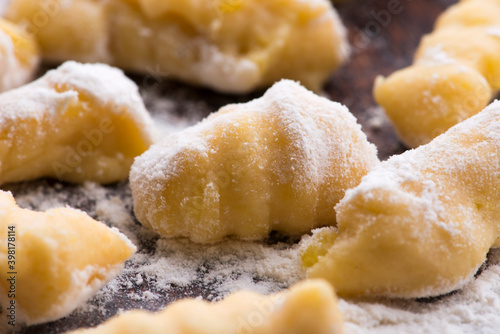 Uncooked homemade potato gnocchi with fork