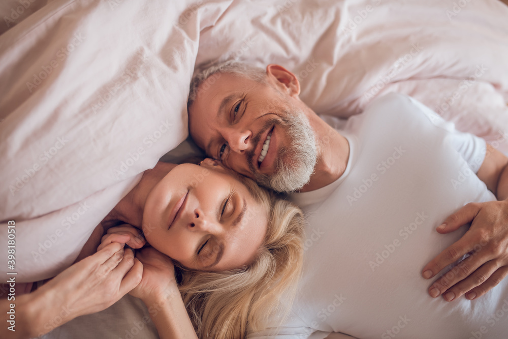 Mature couple having romantic moment in bedroom