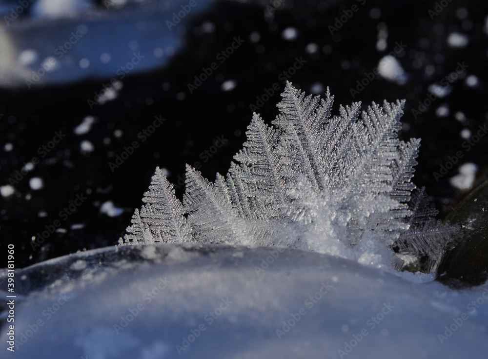 Stunning frozen icicles waterfall on a rocky mountain cliff on a winter day. The winter cascade is frozen in numerous white icicles. Waterfall falling past hundreds of icicles fantastic winter landsca Stunning frozen icicles waterfall on a rocky mountain cliff on a winter day. The winter cascade is frozen in numerous white icicles. Waterfall falling past hundreds of icicles fantastic winter landsca