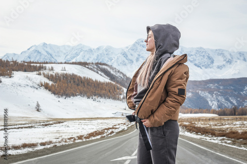 Girl on the background of mountains in winter