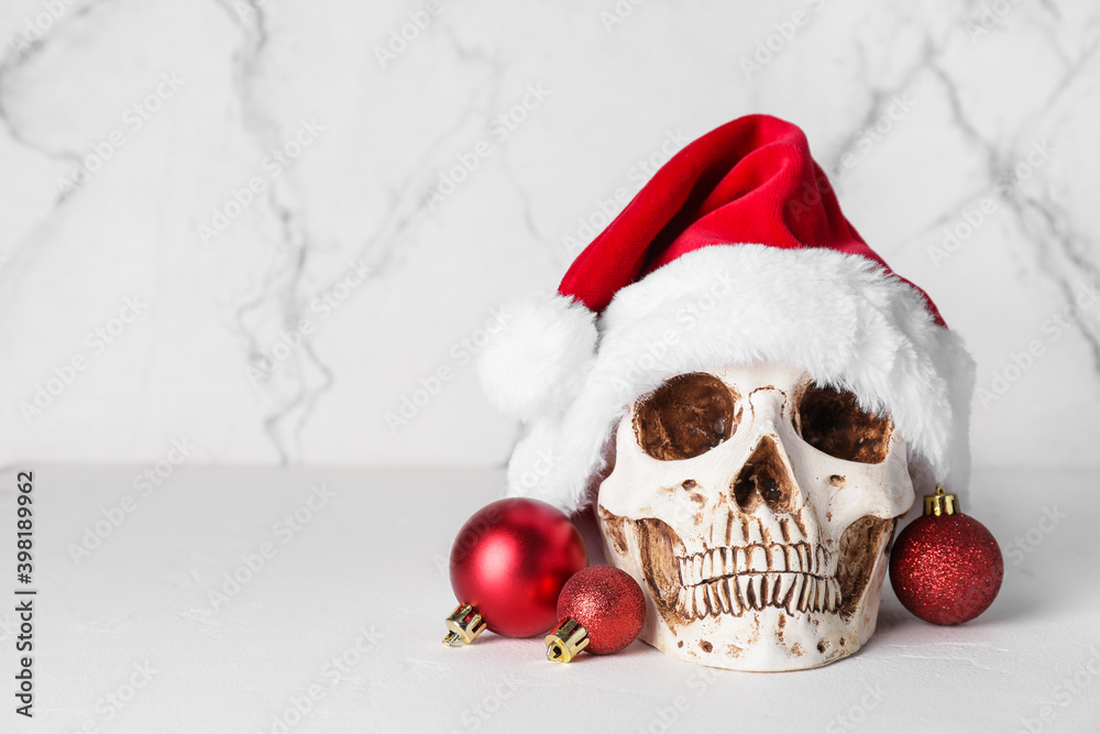 Santa hat with human skull and Christmas balls on white background Santa hat with human skull and Christmas balls on white background
