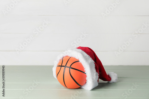 Santa hat with ball for playing basketball on table