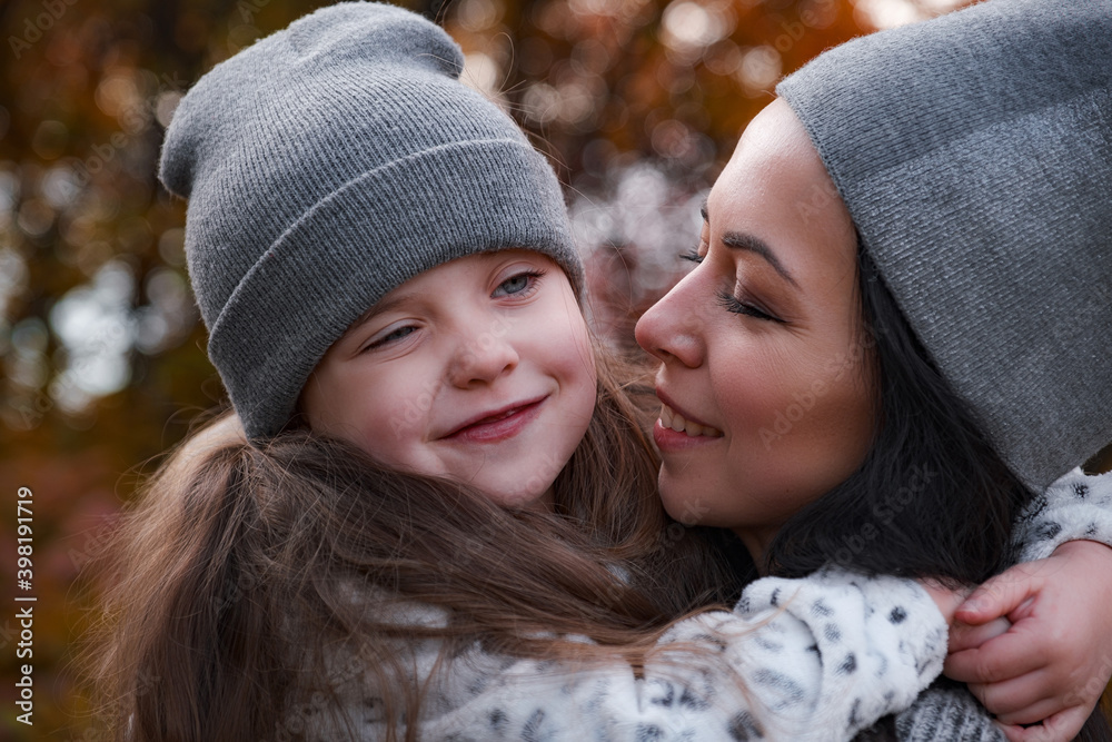 Mother and daughter walking in the park and enjoying autumn nature. Mother and daughter walking in the park and enjoying autumn nature.