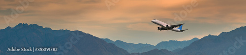 Panoramic view with airplane taken off above mountains, Middle East
