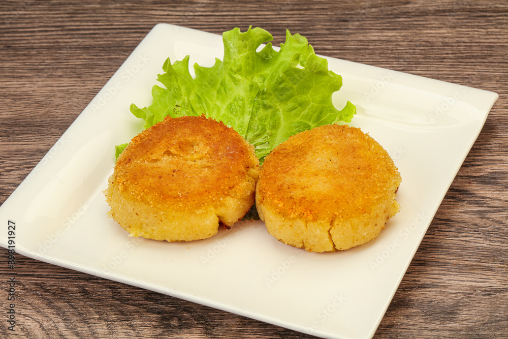 Vegan cuisine - Potato cutlet in the plate Vegan cuisine - Potato cutlet in the plate