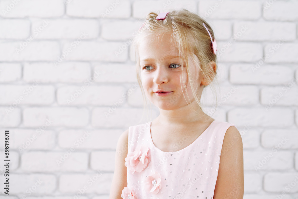 Portrait of a little cute girl in pink dress