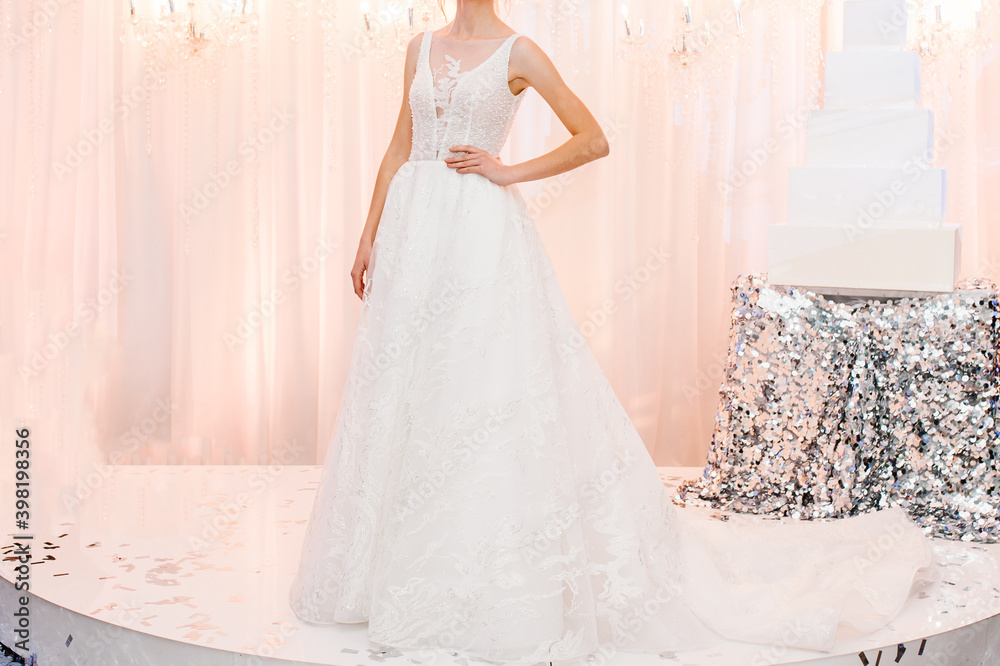 Fototapeta premium Bride at ceremony in wedding day. Woman in an expensive, luxury dress, details of models on the collection catwalk during the Bridal Week runway.