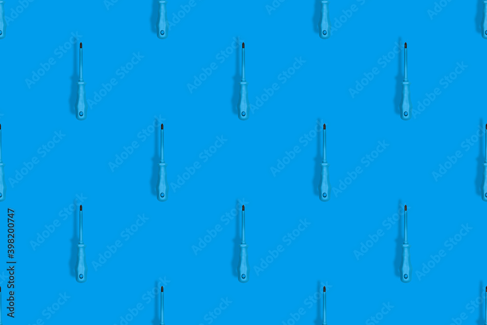 Rubberized metal screwdriver. Screwdriver seamless pattern. Background on the theme of tools.