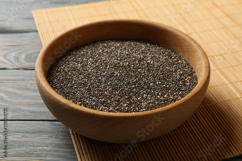 Bowl with chia seeds on wooden background