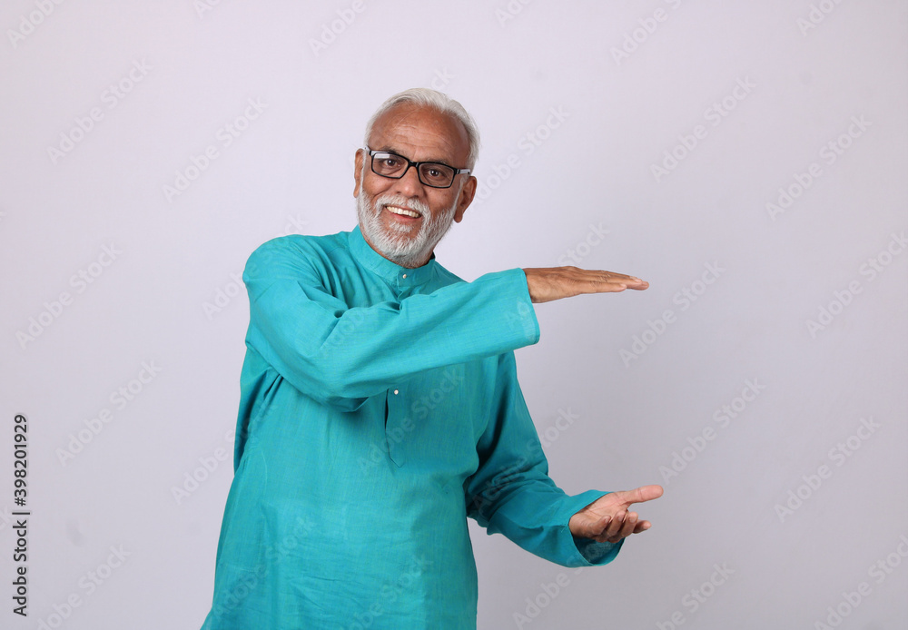 Cool bearded indian old man using mobile phone for video call or taking