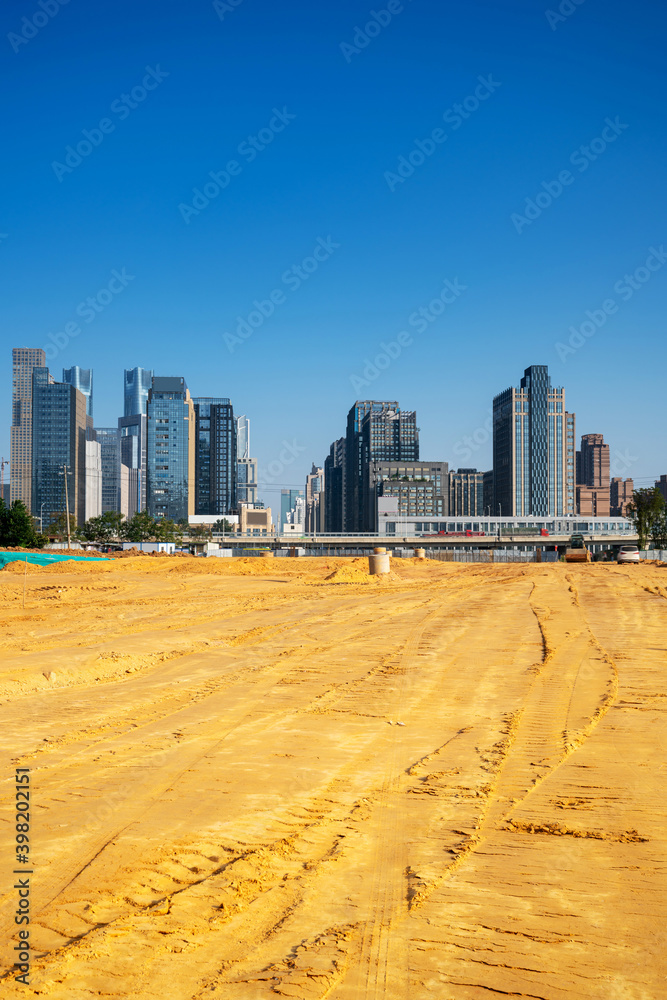A city looks over a cracked earth landscape A city looks over a cracked earth landscape