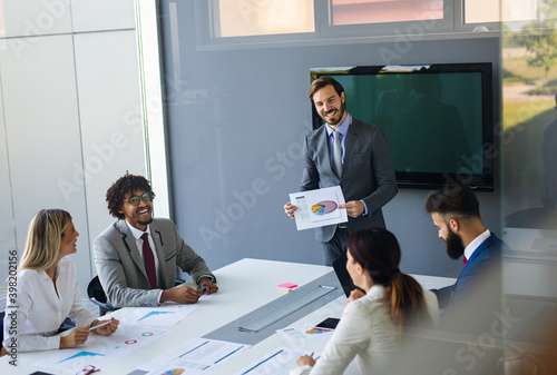 Happy success business people working, brainstoming together in office on meeting photo