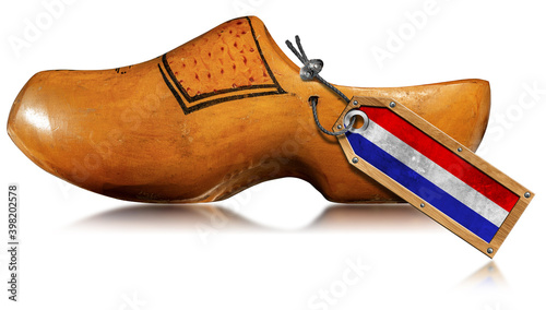 Εκτύπωση καμβά Closeup of a wooden clog made in Netherlands with Dutch flag and isolated on white background with reflections