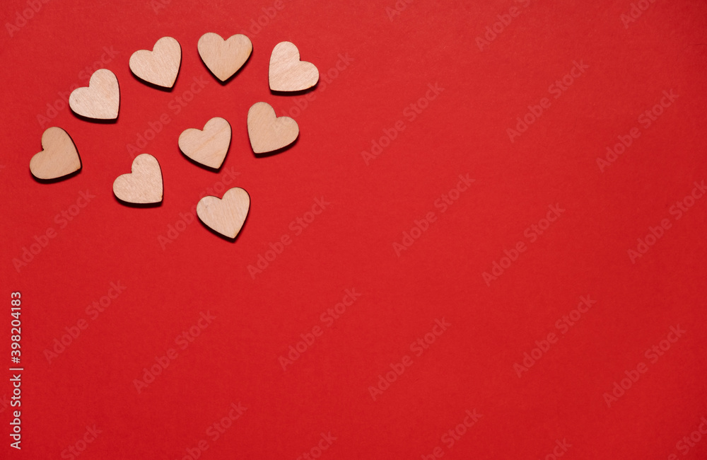 Wooden hearts on a red background with place for text. Valentine's day, mother's day.