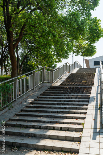 Fototapeta Naklejka Na Ścianę i Meble -  Outdoor Concrete Staircase With Stainless Steel Handrail