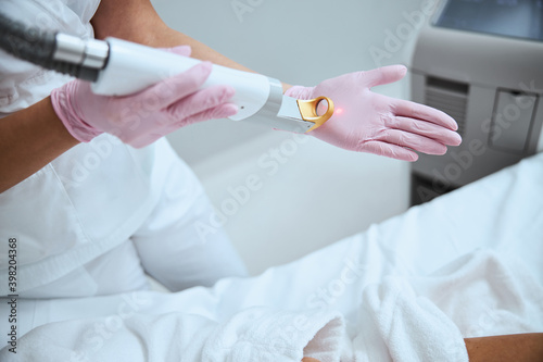Dermatologist testing the beauty device before the procedure