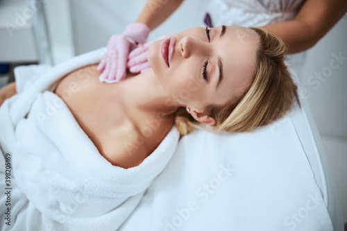 Dermatologist disinfecting the client skin prior to an injection