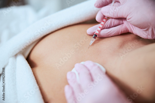 Female patient being injected into the decolletage area