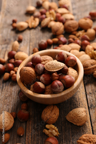 almond on wood background- top view