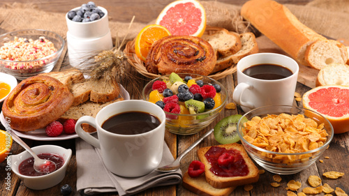 full breakfast- coffee cup, baguette with jam and fruits