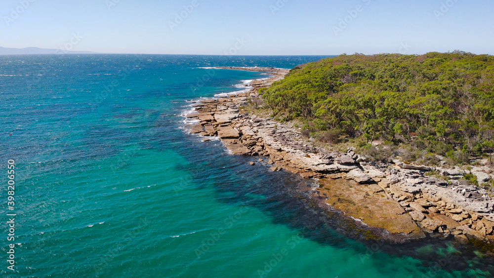 Jervis Bay in Australia. Scenic rocky shore and clear ocean water.