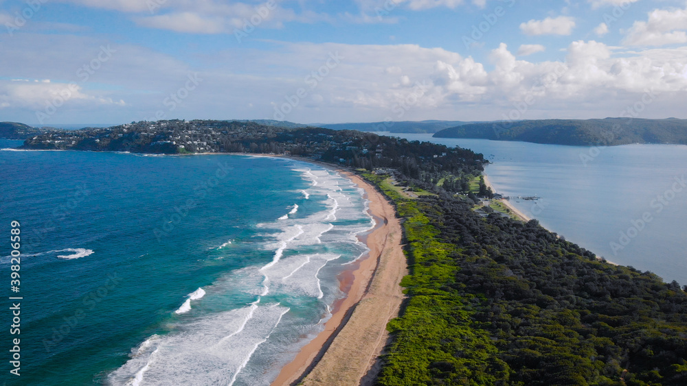 Beautiful, narrow beach line, ocean waves sand and green vegetation. Palm Beach, Australia. Beautiful, narrow beach line, ocean waves sand and green vegetation. Palm Beach, Australia.