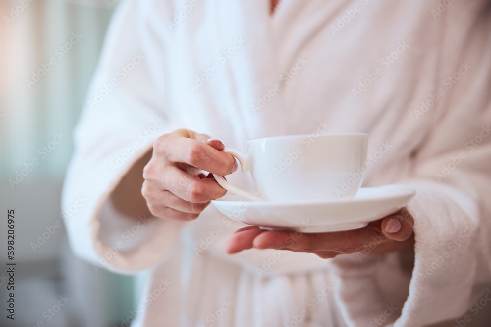 Young female with a cup of herbal beverage Young female with a cup of herbal beverage