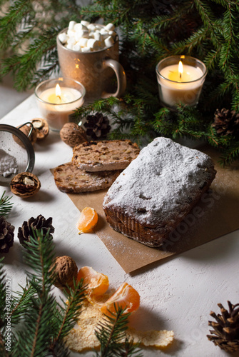 Stollen - traditional German bread eaten during the Christmas season.
Нomemade festive pastry dessert with dried berries, nuts and powdered sugar.