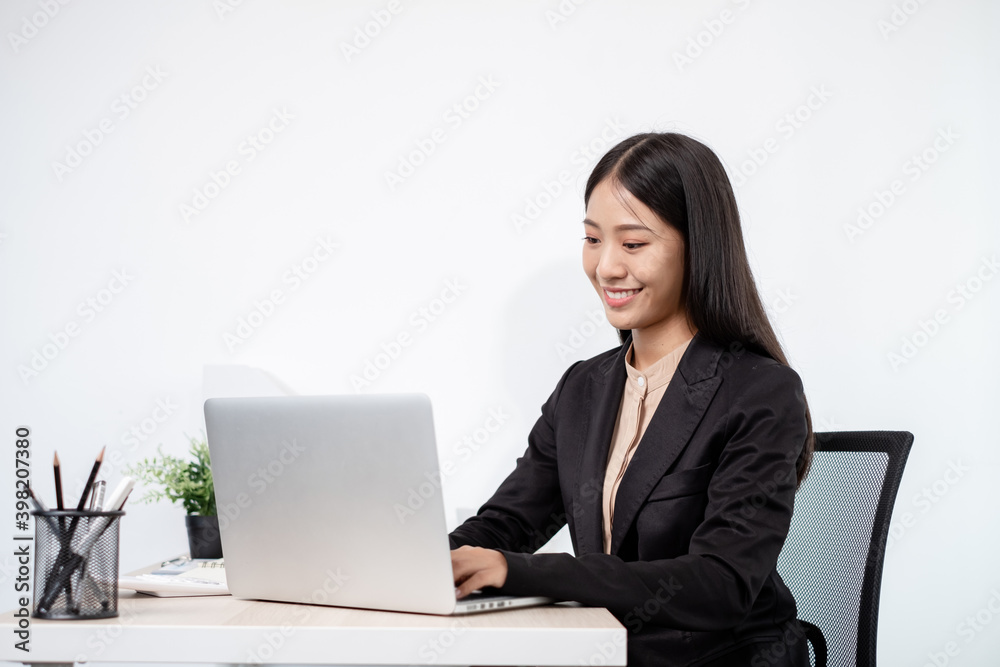 Asian businesswomen sit at their desks and calculate financial graphs showing results about their investments, plan a successful business growth process in the office Asian businesswomen sit at their desks and calculate financial graphs showing results about their investments, plan a successful business growth process in the office