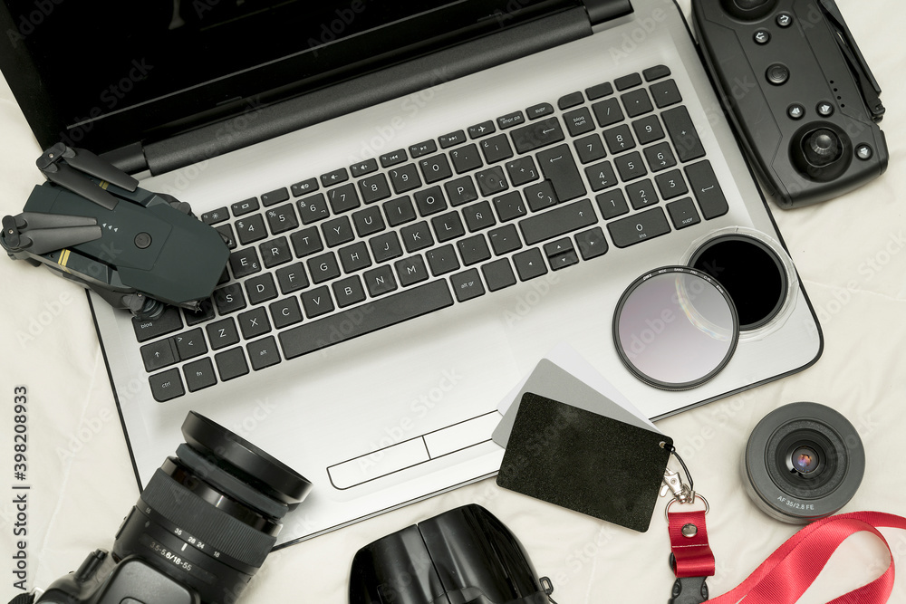 Composition with camera and photo and video production equipment with camera, drone, filters and more accessories on white background, top view.. Composition with camera and photo and video production equipment with camera, drone, filters and more accessories on white background, top view..