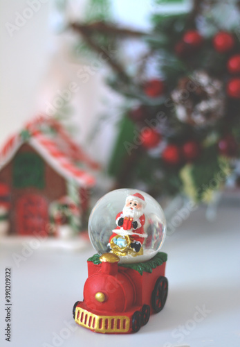 Christmas snow globe.  Train toy carrying snow globe with Santa Claus. New Year decoration. photo