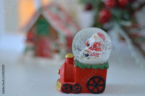 Christmas snow globe.  Train toy carrying snow globe with Santa Claus. New Year decoration. photo