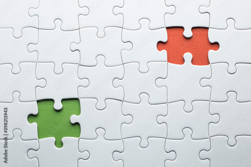 puzzle is missing two pieces to be completed in different colors. white pieces and one piece in green and one in orange to add text puzzle is missing two pieces to be completed in different colors. white pieces and one piece in green and one in orange to add text