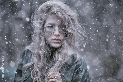 Fototapeta Naklejka Na Ścianę i Meble -  girl romantic portrait first snow autumn, snowflakes blurred background seasonal winter