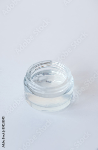 Jar with cosmetic moisturizing gel for face or body on light background