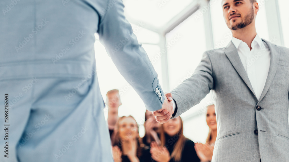 confident young business people meet each other with a handshake. confident young business people meet each other with a handshake.