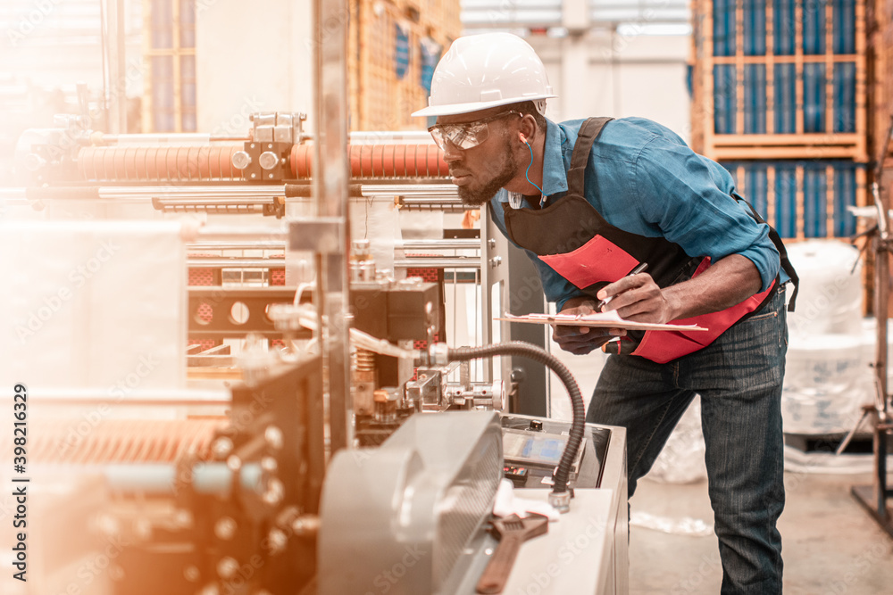 Technician working in factory check functionality while commissioning a production line, Man working Technician working in factory check functionality while commissioning a production line, Man working