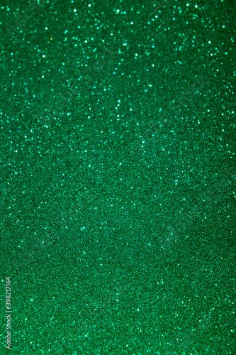 Green color blured sparkling background with focused area.