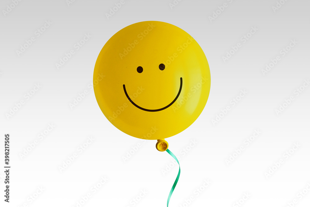 Yellow balloon with smile on white background - Concept of optimism and positive thinking - obrazy, fototapety, plakaty 