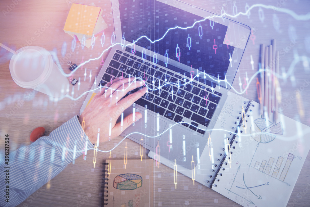 Double exposure of man's hands typing over computer keyboard and forex graph hologram drawing. Top view. Financial markets concept. Double exposure of man's hands typing over computer keyboard and forex graph hologram drawing. Top view. Financial markets concept.
