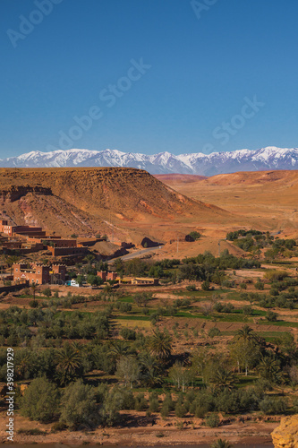 Village Tamedakhte with its oasis, in the background the snow covered summits of mountain Atlas © vaios karalaios