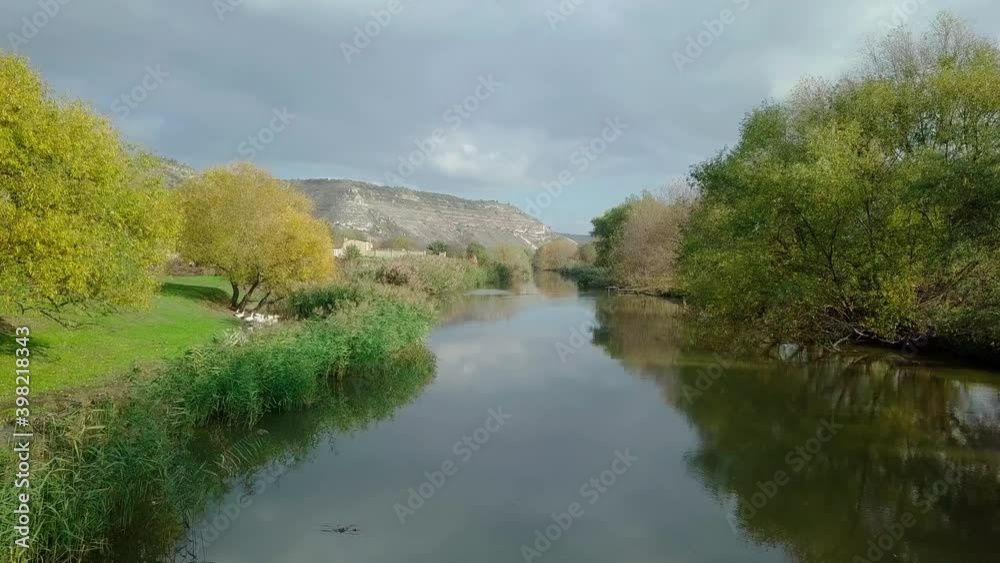 Drone flight over the river and smal moldavian village in autumn landscape. Moldova republic of. Drone flight over the river and smal moldavian village in autumn landscape. Moldova republic of.