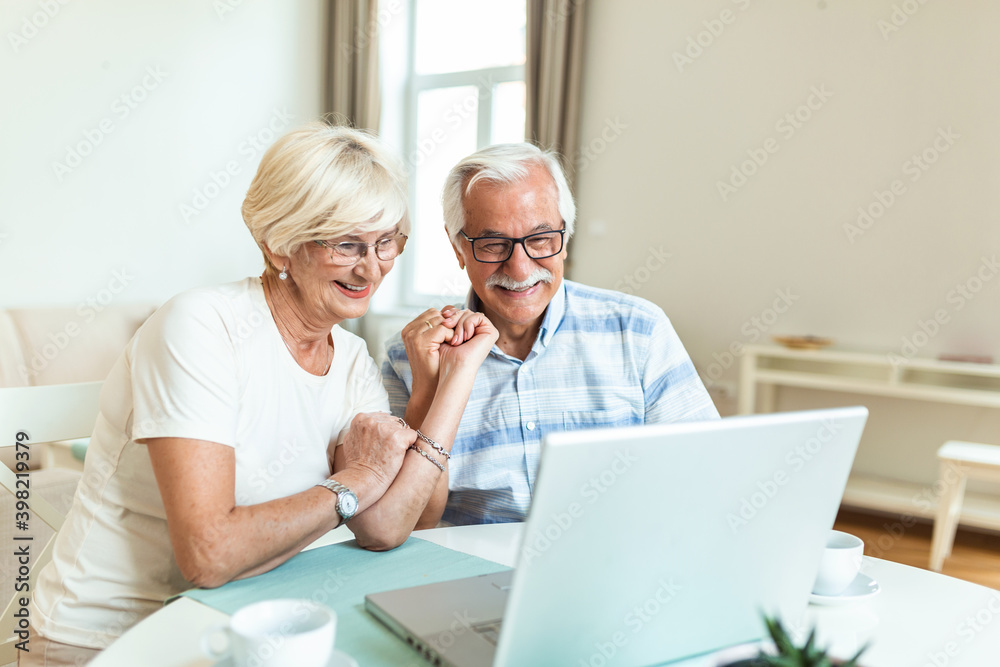 Senior couple is talking online via video connection on the laptop. Having nice time withfriends and family via video call.Holding their hands together Senior couple is talking online via video connection on the laptop. Having nice time withfriends and family via video call.Holding their hands together